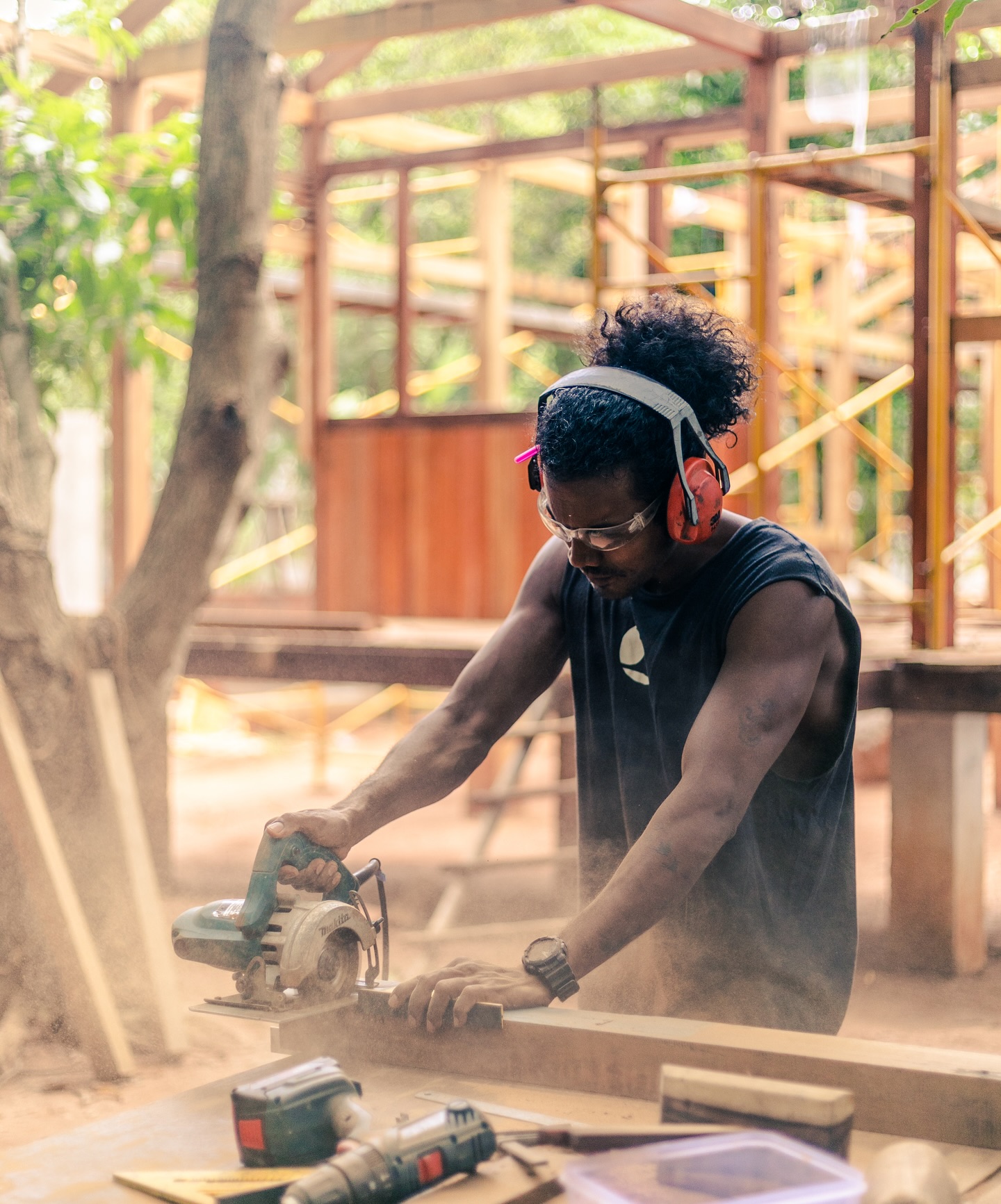 Sankar working with power tools during the early construction of Keeth House